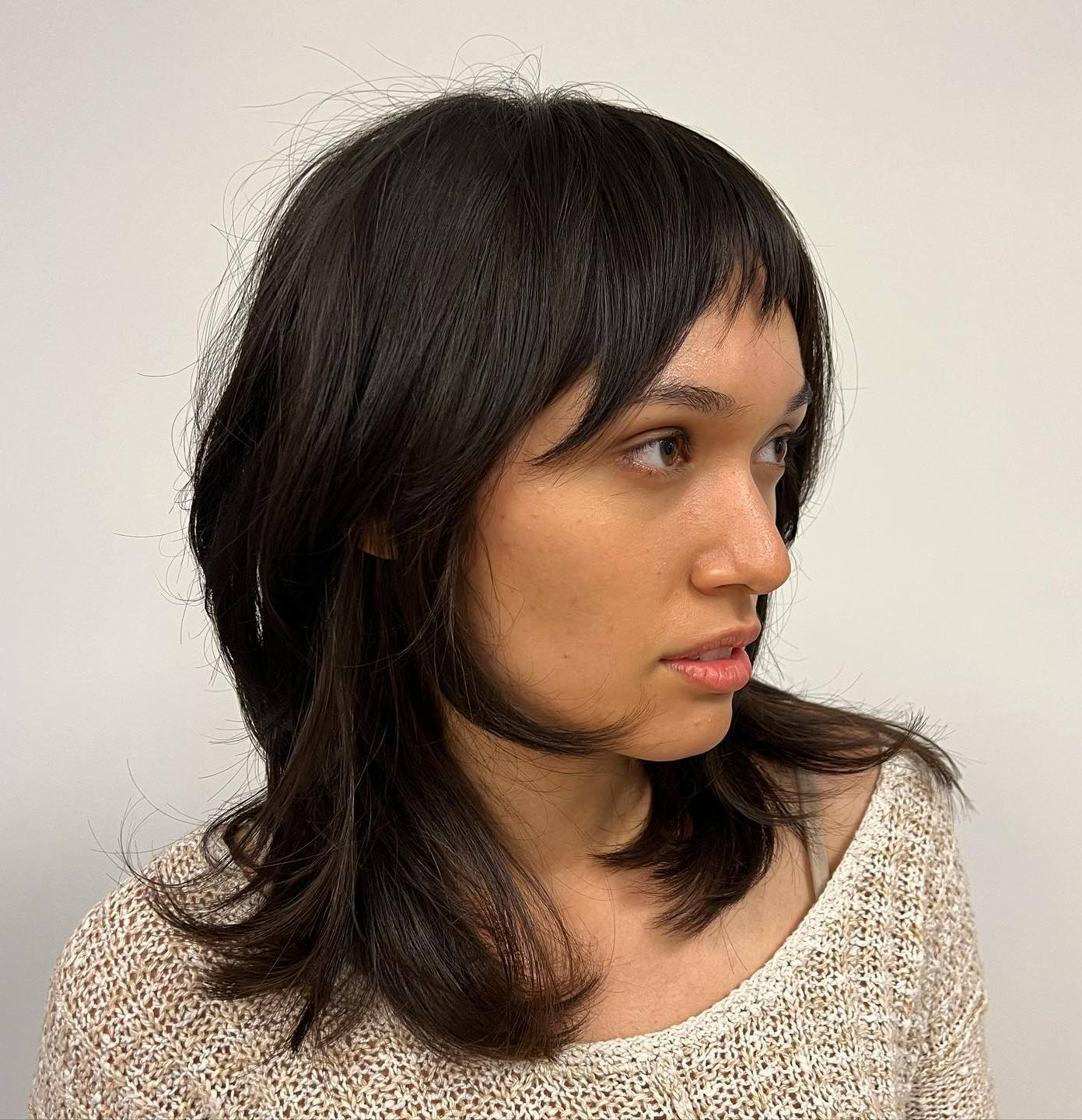 Medium Hairstyle with Angled Layers and Bangs